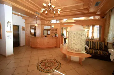 a large kitchen with a bar and a restaurant at Hotel Chalet Sas Morin in Pozza di Fassa