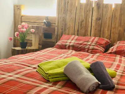 a bed with green towels and flowers on it at Cèsa Mia in Campitello di Fassa