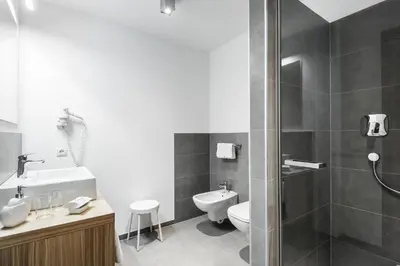 a bedroom with a large bed and a desk at Hotel Miramonti Badia in Badia
