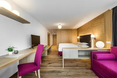 a restaurant with tables and chairs and a bar at Hotel Miramonti Badia in Badia