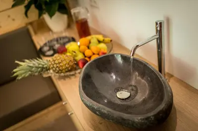 a sink in a counter with a bowl of fruit at Hotel Miramonti Badia in Badia
