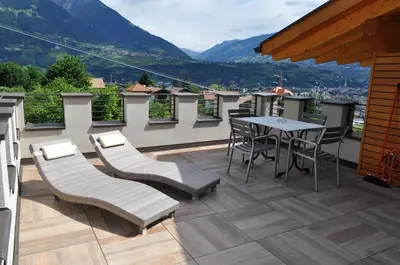 a balcony with a table and chairs and a view at B&B - Apartments Sunnwies in Marlengo