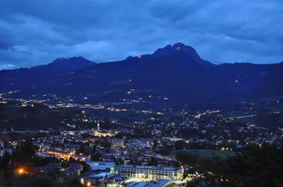 a view of a city at night with a mountain at B&B - Apartments Sunnwies in Marlengo