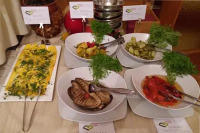a table with many plates of food on it at B&B - Apartments Sunnwies in Marlengo