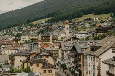 a view of a town with houses and a mountain at Hotel Garni Planaces in Ortisei