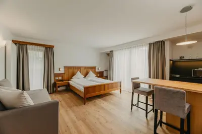 a living room with a couch and a table at Hotel Garni Planaces in Ortisei