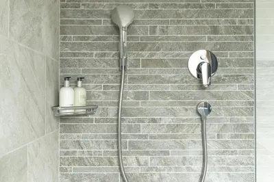 a shower with a shower head in a bathroom at Garni Hotel Geier in Santa Cristina in Val Gardena