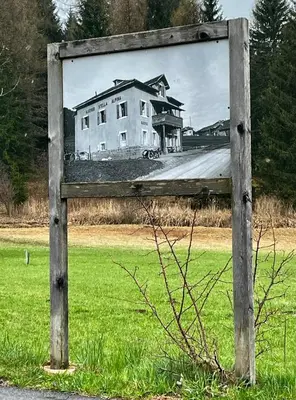 a painting of a house in a field at Hotel Stella Alpina in Bellamonte