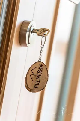 a key chain attached to a door with the word entrance at Tallnerhof in Schenna