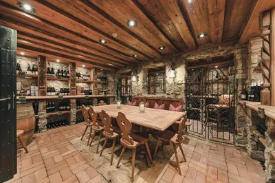 a dining room with a wooden table and chairs at Hotel Viertler in Avelengo