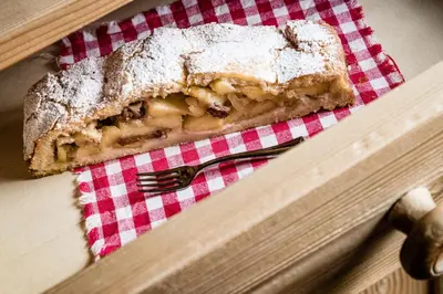 a piece of bread on a napkin with a fork at Boutique Hotel Nives - Luxury & Design in the Dolomites in Selva di Val Gardena