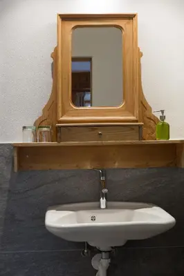 a bathroom with a mirror and a sink at Garni Bachlerhof in Brunico