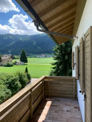 a porch with a fence and a view of a field at Appartments Hilber in Brunico