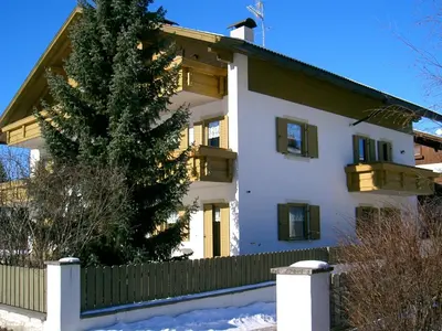 a house with a christmas tree in front of it at Appartments Hilber in Brunico