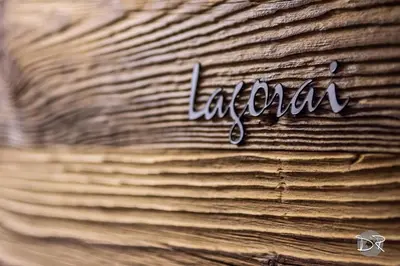 a sign that says la canada written on a stack of wood at Casa de Fiemme in Tesero