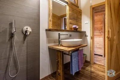 a bathroom with a sink and a shower at Casa de Fiemme in Tesero