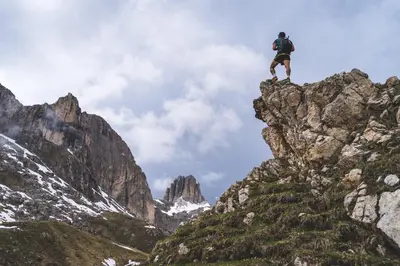 a man standing on top of a rocky mountain at Hotel Marica in Eggen
