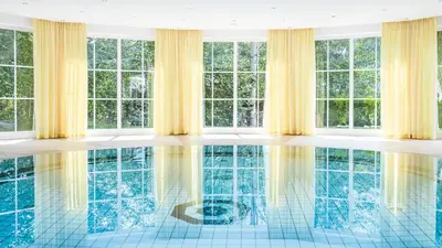 a room with a pool with windows at Hotel Marica in Eggen