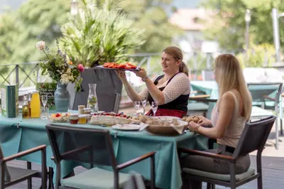 two women sitting at a table with a tray of food at Hotel Marica in Eggen
