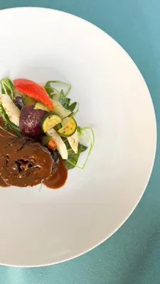 a white plate of food on a table at Hotel Marica in Eggen