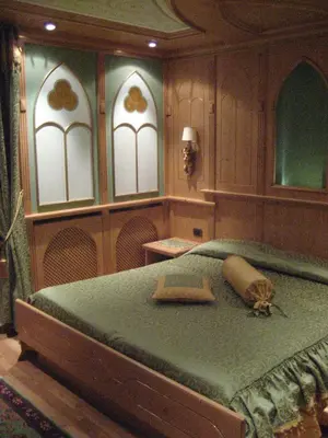 a bedroom with a bed with a turtle on it at Hotel Letizia in San Martino di Castrozza