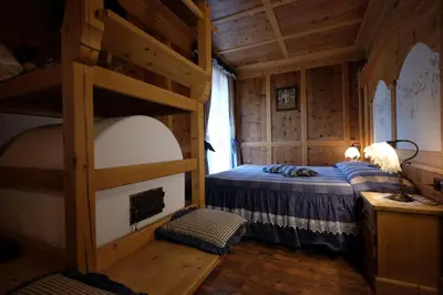 a bedroom with two bunk beds in a cabin at Hotel Letizia in San Martino di Castrozza