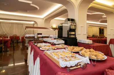 a long table with plates of food on it at Albergo Conca Verde in Fiera di Primiero