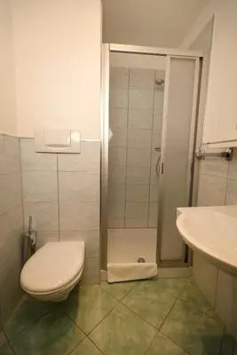 a bathroom with a shower with a toilet and a sink at Hotel Marlingerhof in Marlengo
