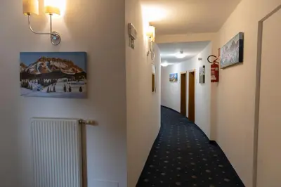 a corridor of a hospital with a hallway at Hotel Marlingerhof in Marlengo