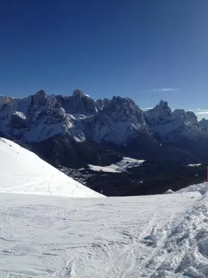 a snow covered mountain range with mountains in the background at B&B La Montanara in San Martino di Castrozza