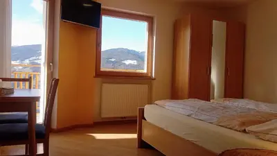 a bedroom with a bed and a window at Agriturismo Ferienhof Gschloier - Adults Only in Laion