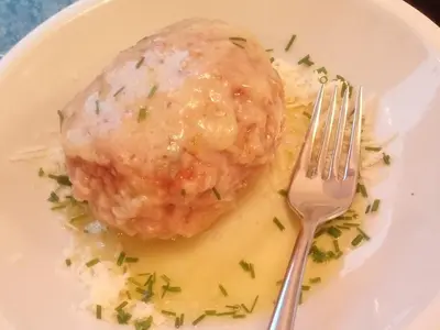 a plate of food with a meat ball on rice at Agriturismo Ferienhof Gschloier - Adults Only in Laion