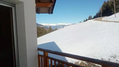 a view of a snow covered mountain from a balcony at Agriturismo Ferienhof Gschloier - Adults Only in Laion