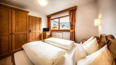 a bedroom with two white pillows on a bed at Apartments Chalet Maria in Badia