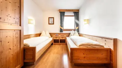 a room with two beds and a window at Apartments Chalet Maria in Badia