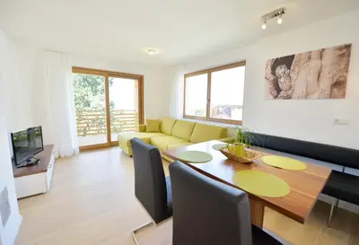 a living room with a table and a yellow couch at Appartment Silvia in St Andrä bei Brixen in Bressanone