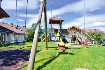 a playground with a slide and swings at Appartment Silvia in St Andrä bei Brixen in Bressanone