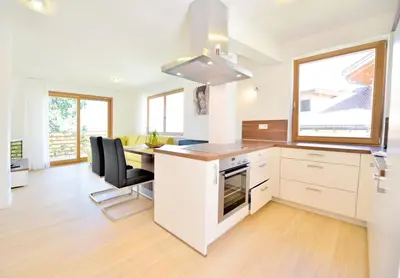 a kitchen with a desk and a table with chairs at Appartment Silvia in St Andrä bei Brixen in Bressanone