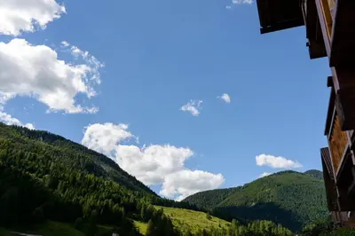 a view of the mountains from a building at FORESTO holiday apartments in Tesero