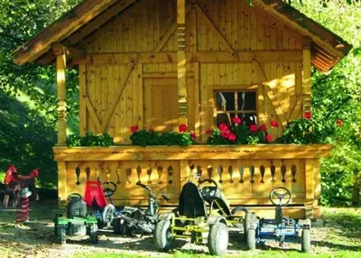 a small wooden cabin with motorcycles parked in front of it at Hotel Mair Am Bach in Bressanone