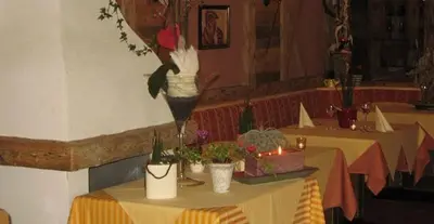 a table with potted plants on it in a restaurant at Hotel Mair Am Bach in Bressanone