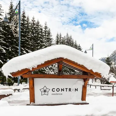 a sign with snow on top of it at Residence Contrin in Canazei