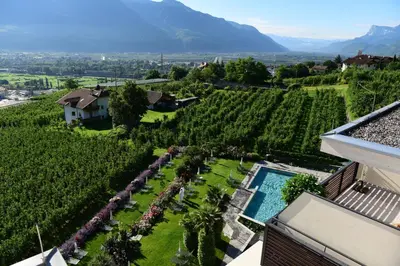 an aerial view of a vineyard with a house and a pool at Giardino Marling in Merano