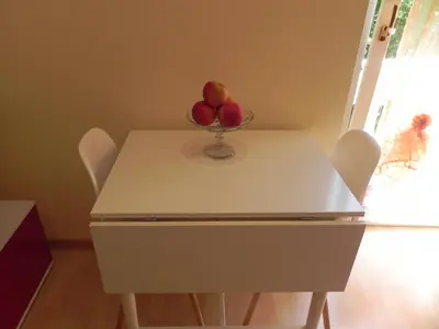 a table with a bowl of apples on top of it at Casa Vacanze Monachy in Merano