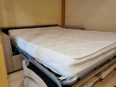 a mattress on a bed frame in a room at Casa Vacanze Monachy in Merano