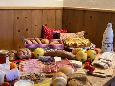 a table topped with lots of different types of food at Agriturismo La Canonica in Brez
