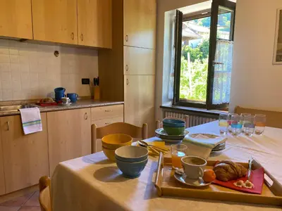 a kitchen with a table with a plate of food on it at Agriturismo La Canonica in Brez
