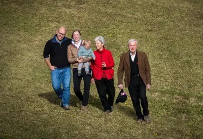 a group of people walking in the grass at Agritur Ciasa Dò Parè in Soraga