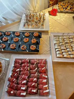 a table with several trays of different types of food at Hotel Malder in Soraga