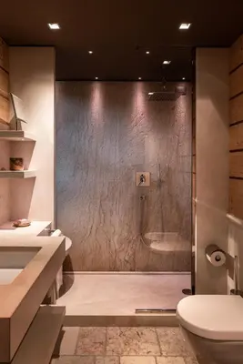 a bathroom with a shower with a toilet and a sink at Rosapetra SPA Resort - Small Luxury Hotels of the World in Cortina dʼAmpezzo